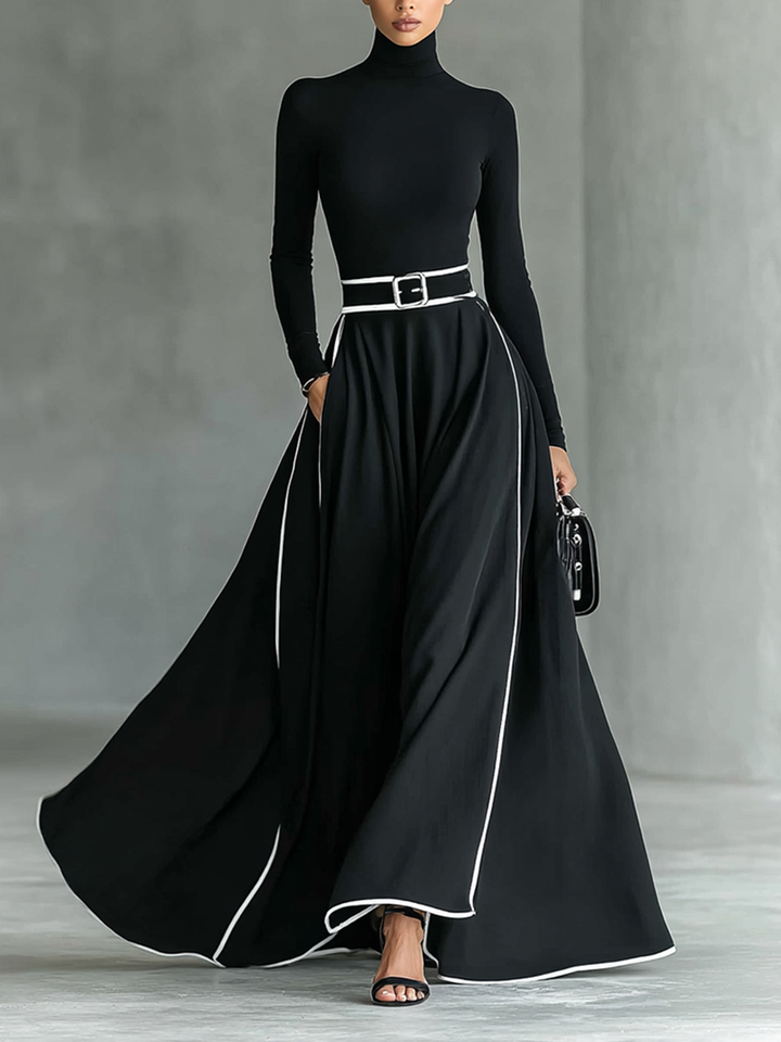 Robe longue noire avec bordure blanche, col montant, manches longues et ceinture