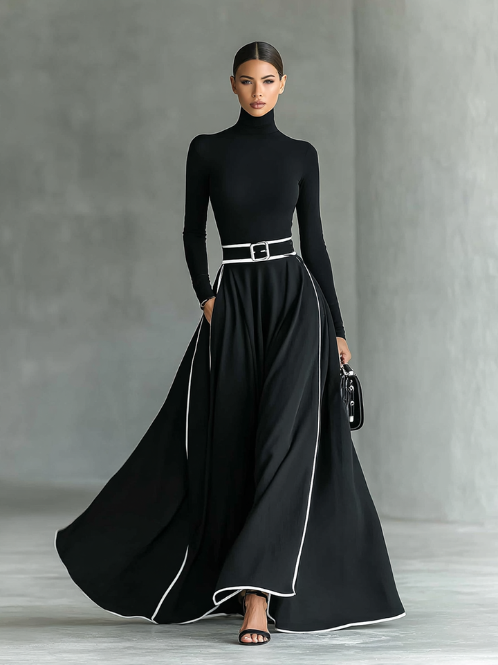 Robe longue noire avec bordure blanche, col montant, manches longues et ceinture