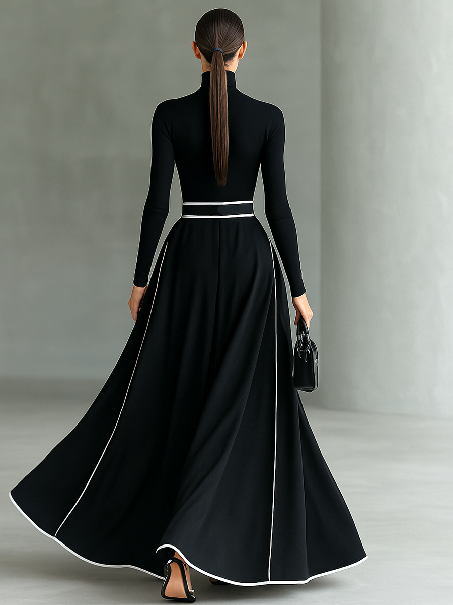 Robe longue noire avec bordure blanche, col montant, manches longues et ceinture